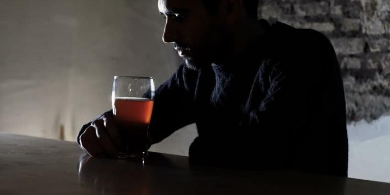 A depressed man drinking alcohol